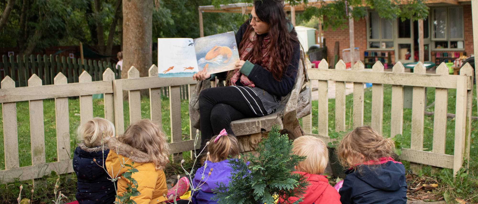 anna-reading-to-children-in-garden